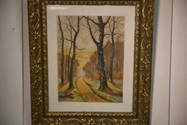 Lithograph of a woodland path, gilt frame, with embossed foliage decoration, 1950s
