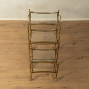 Set of 3 vintage Hollywood Regency nesting tables with brass frame and glass tops (1960s)