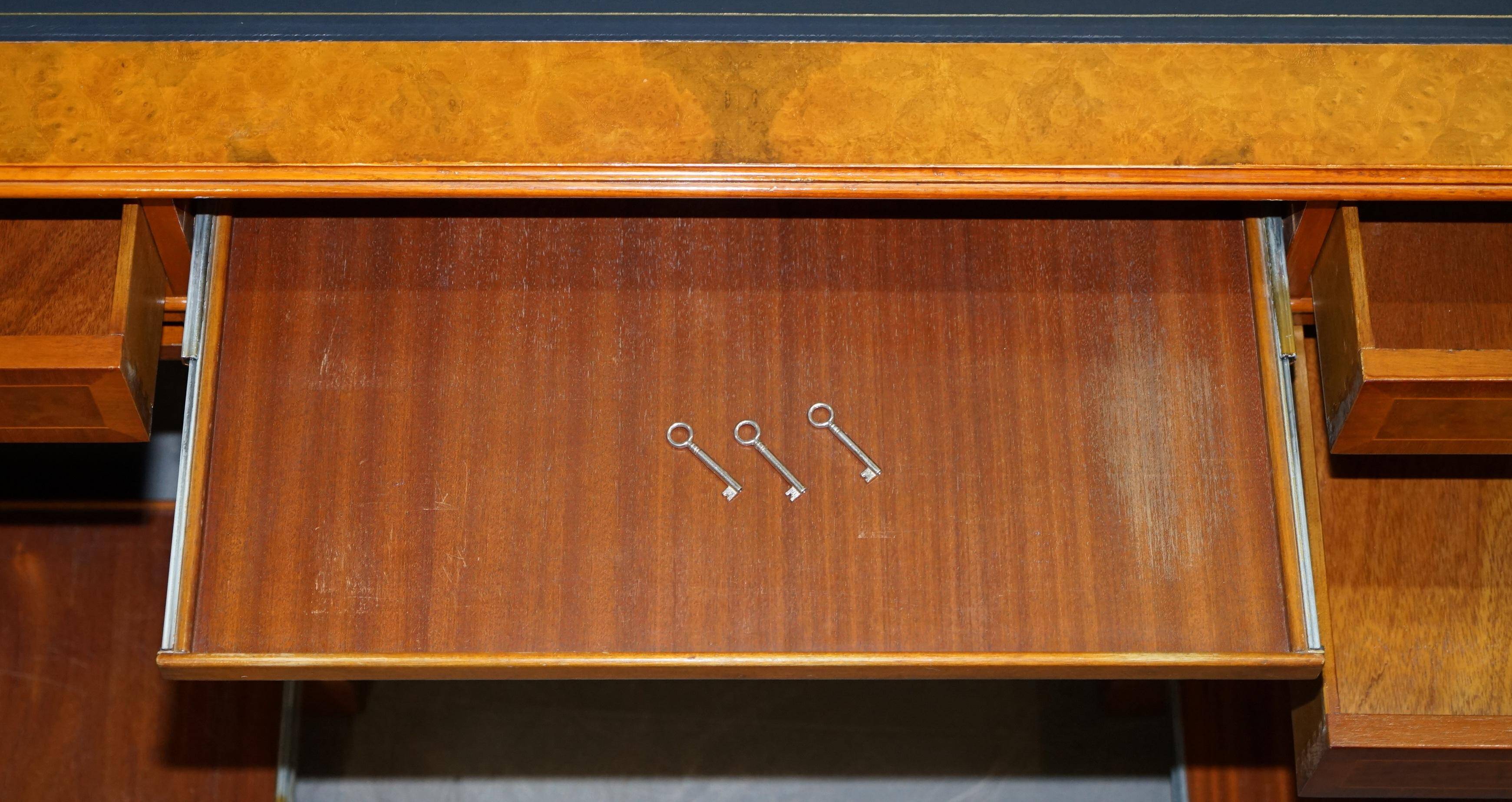 Partner desk in burr walnut designed to conceal computer equipment.