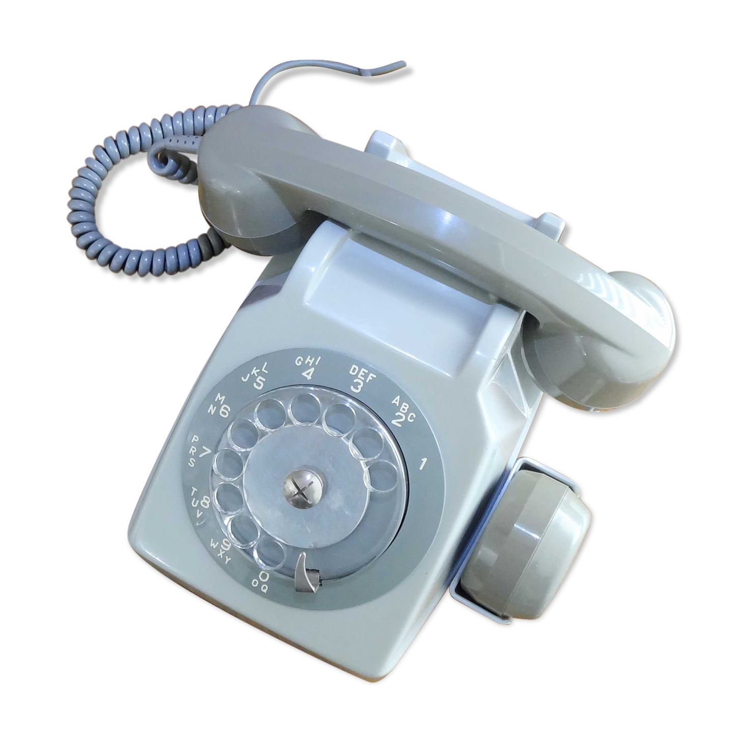 Grey vintage rotary dial phone with earpiece
