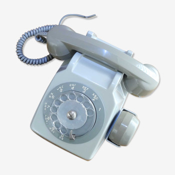 Grey vintage rotary dial phone with earpiece