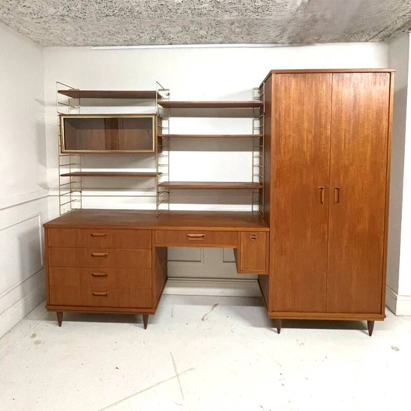 A piece of furniture combining a desk, wardrobe, and shelves.