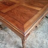 Antique French walnut table with six drawers, parquet top, early 20th century.