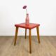 Wooden stool with red faux leather from the 1950s.