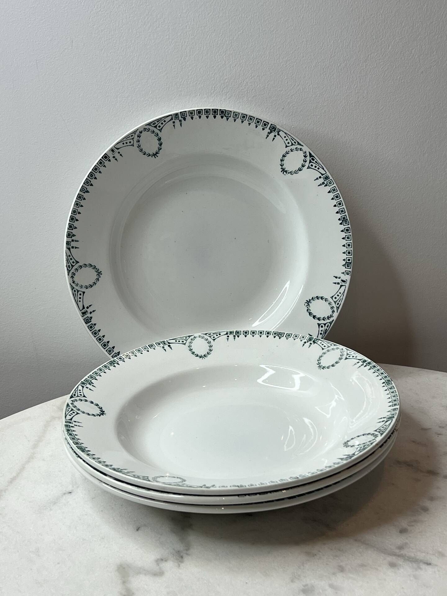 Set of 4 deep plates from Saint Amand with laurel wreath decoration.