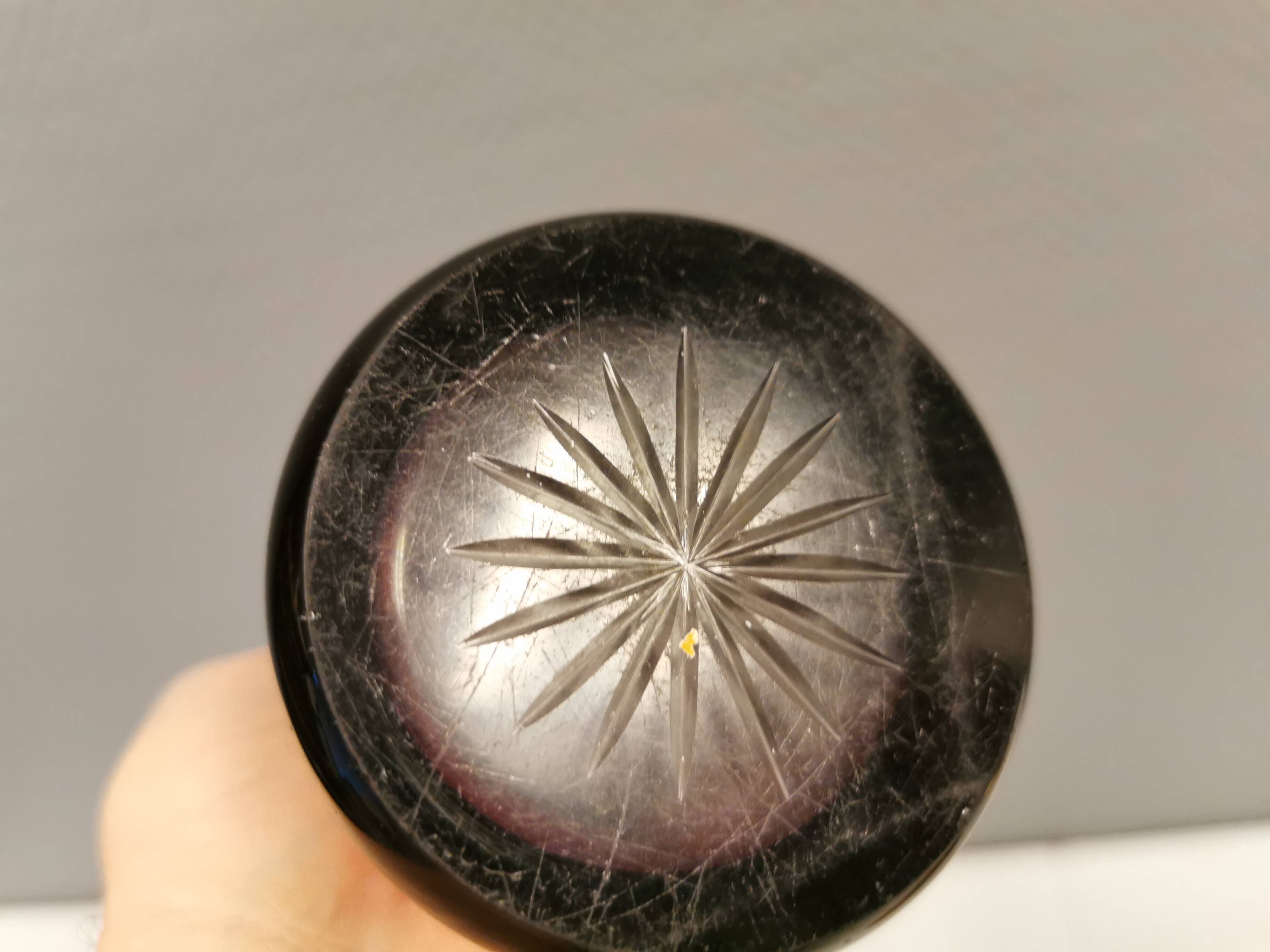 Crystal glass vase, in burgundy/reddish coloured glass with translucent details.