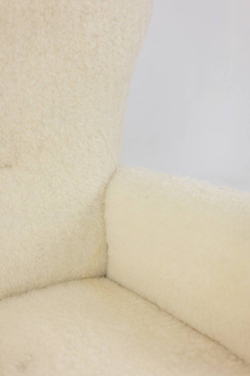 Armchair, or bergère, with its boucle fabric. 1950s