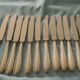 Set of 12 cheese or fruit knives with silver metal handles.