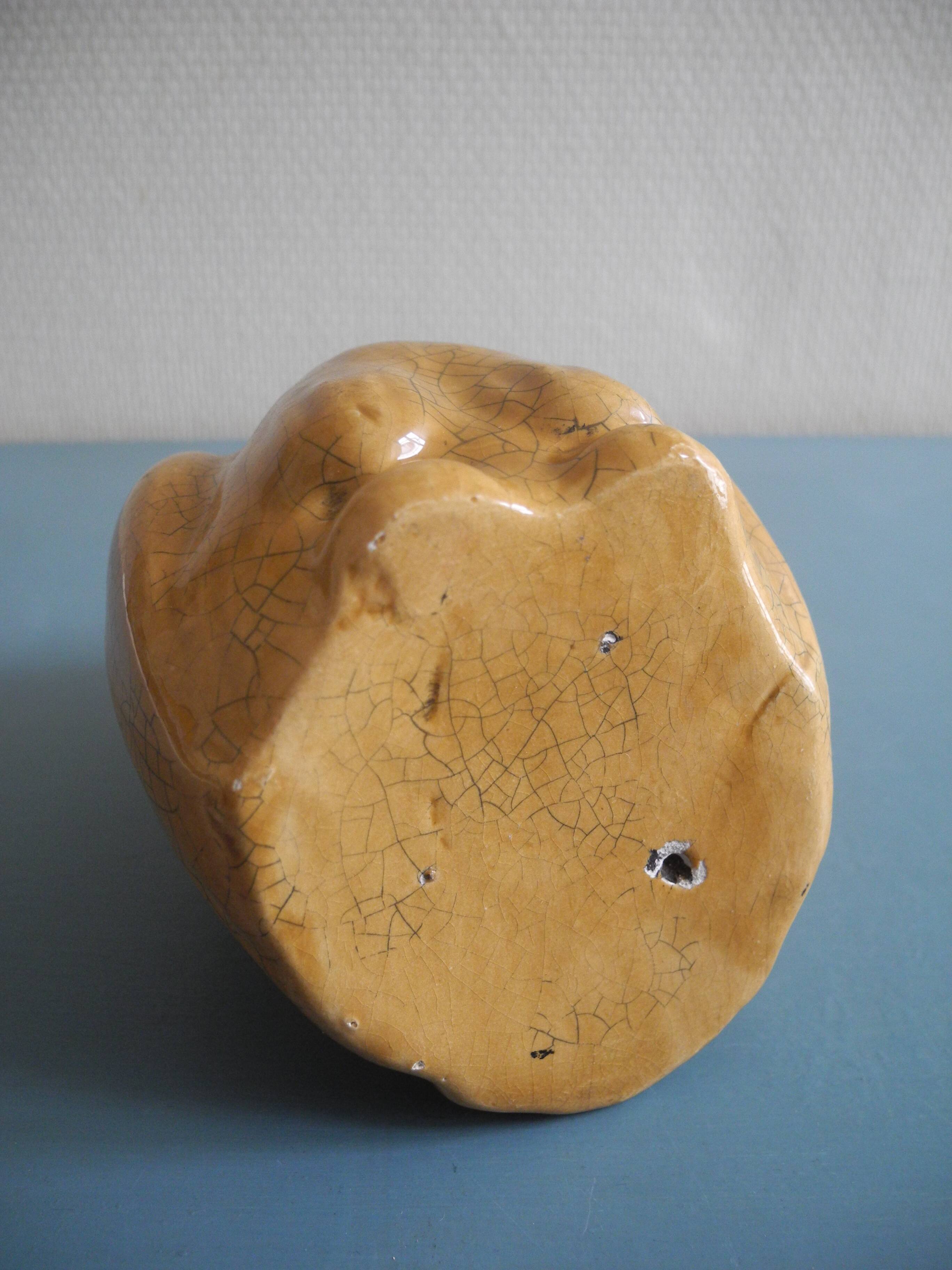 vintage earthenware vase with an old flower pick and an owl decoration