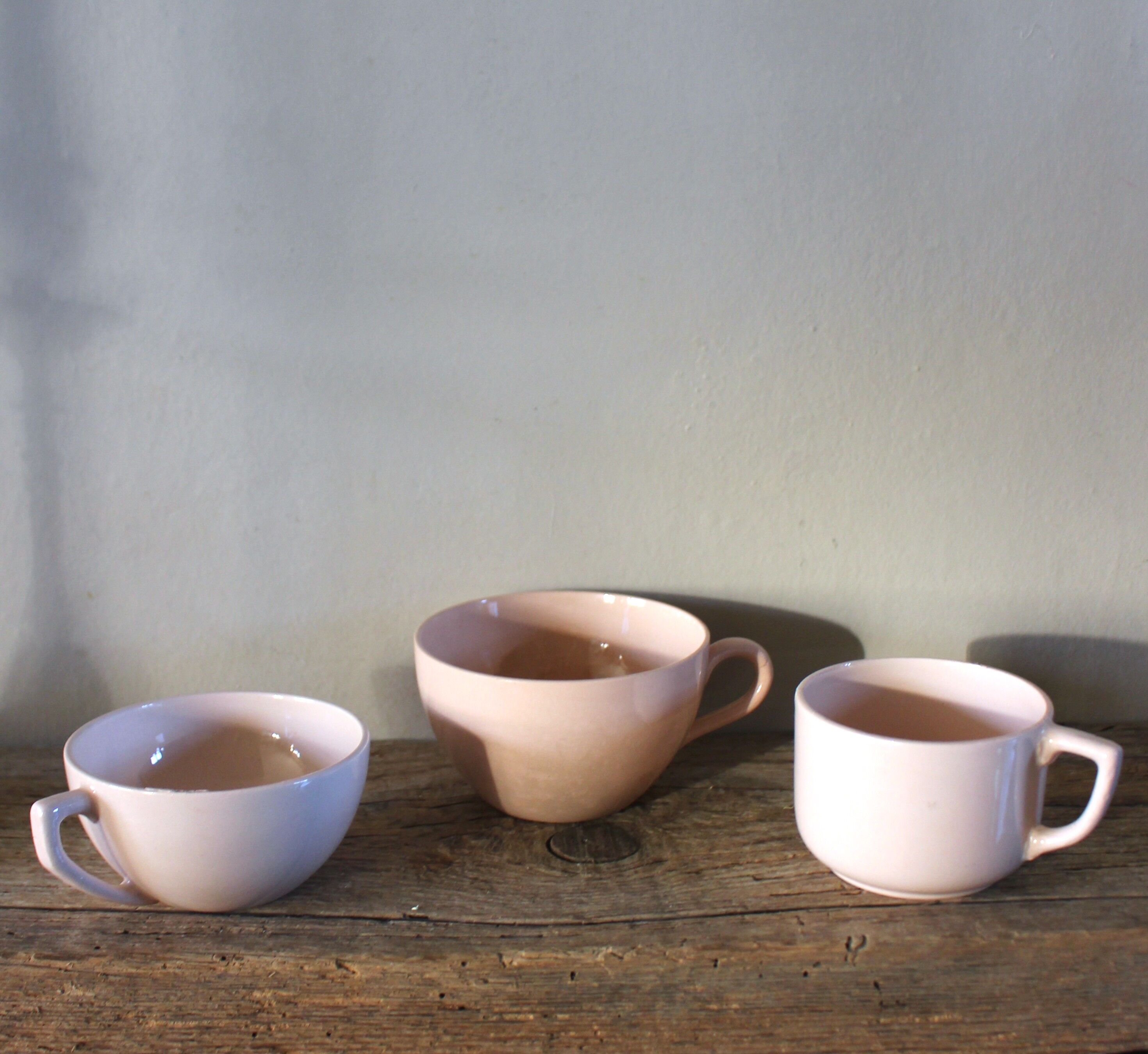 A set of 3 pink earthenware cups from Digoin Sarreguemines.