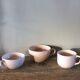A set of 3 pink earthenware cups from Digoin Sarreguemines.