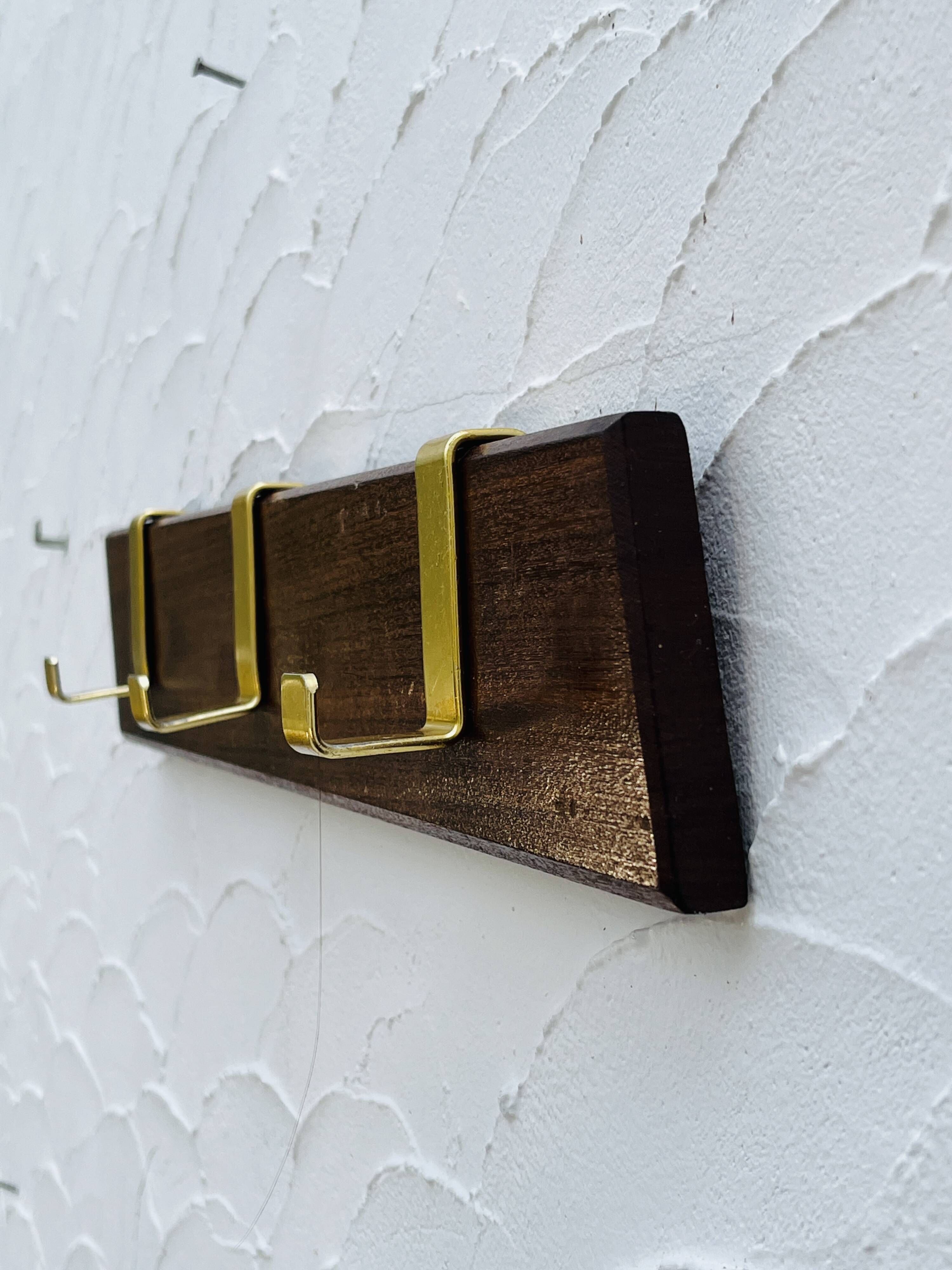 Vintage wooden and brass coat rack with 3 hooks from the 1960s.