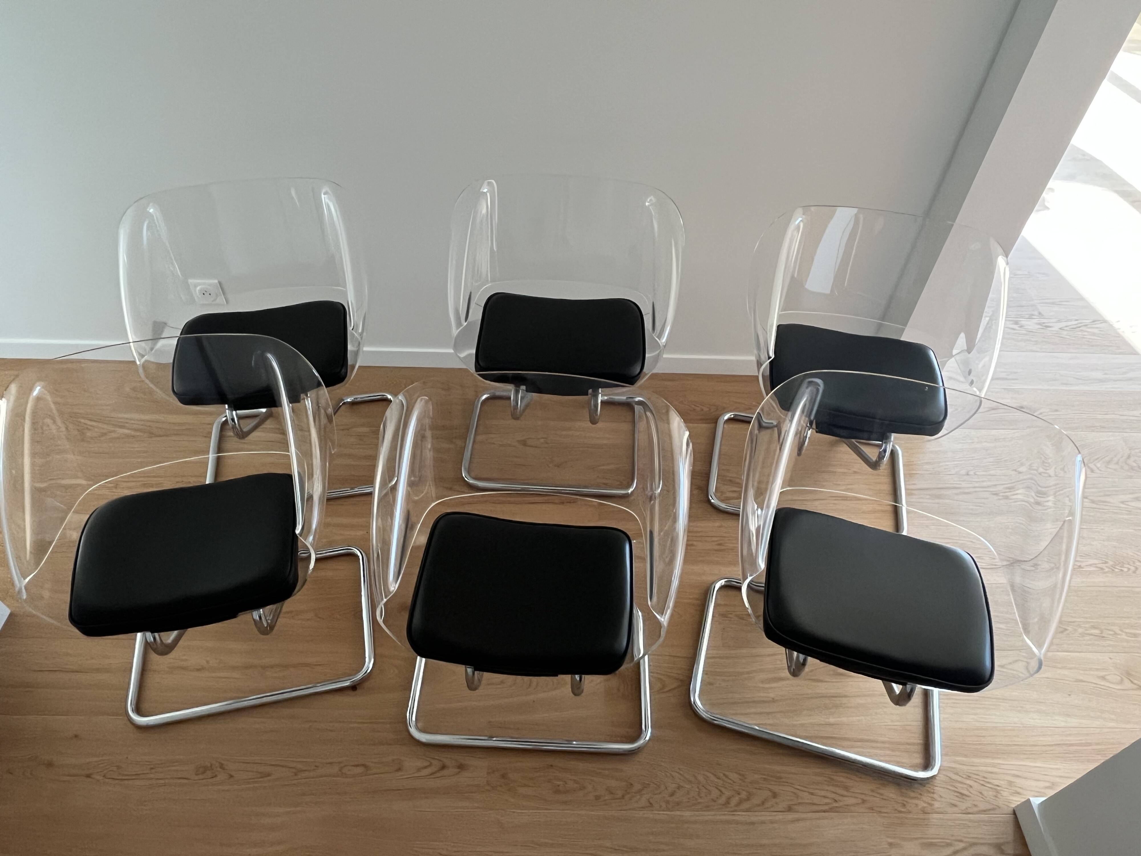 1970s chairs in acrylic and metal designed by Harvey Guzzini.