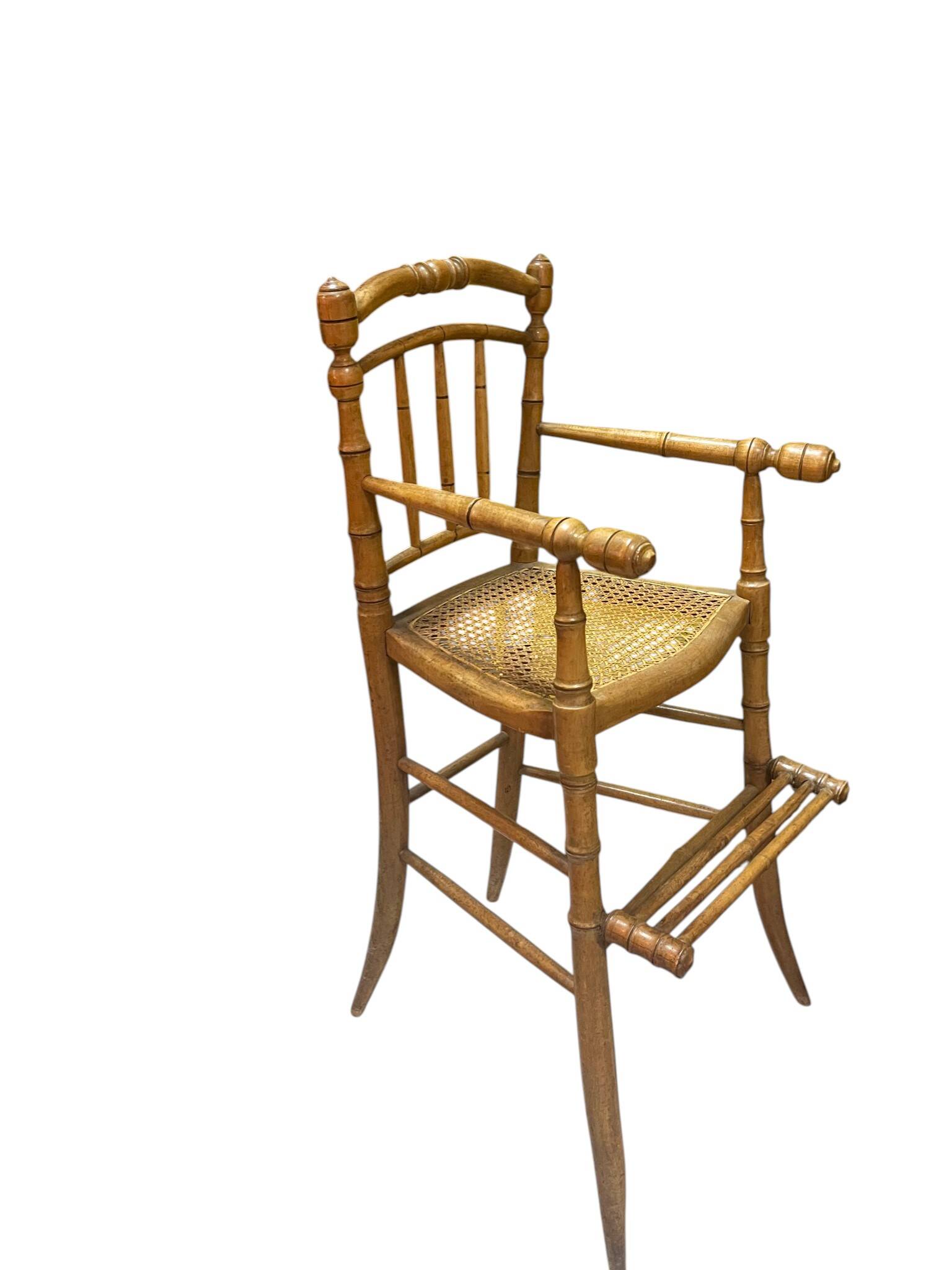 Antique bamboo caned baby chair from the early 20th century.