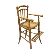 Antique bamboo caned baby chair from the early 20th century.