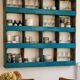 Antique wall cabinet in patinated turquoise blue wood, workshop style.