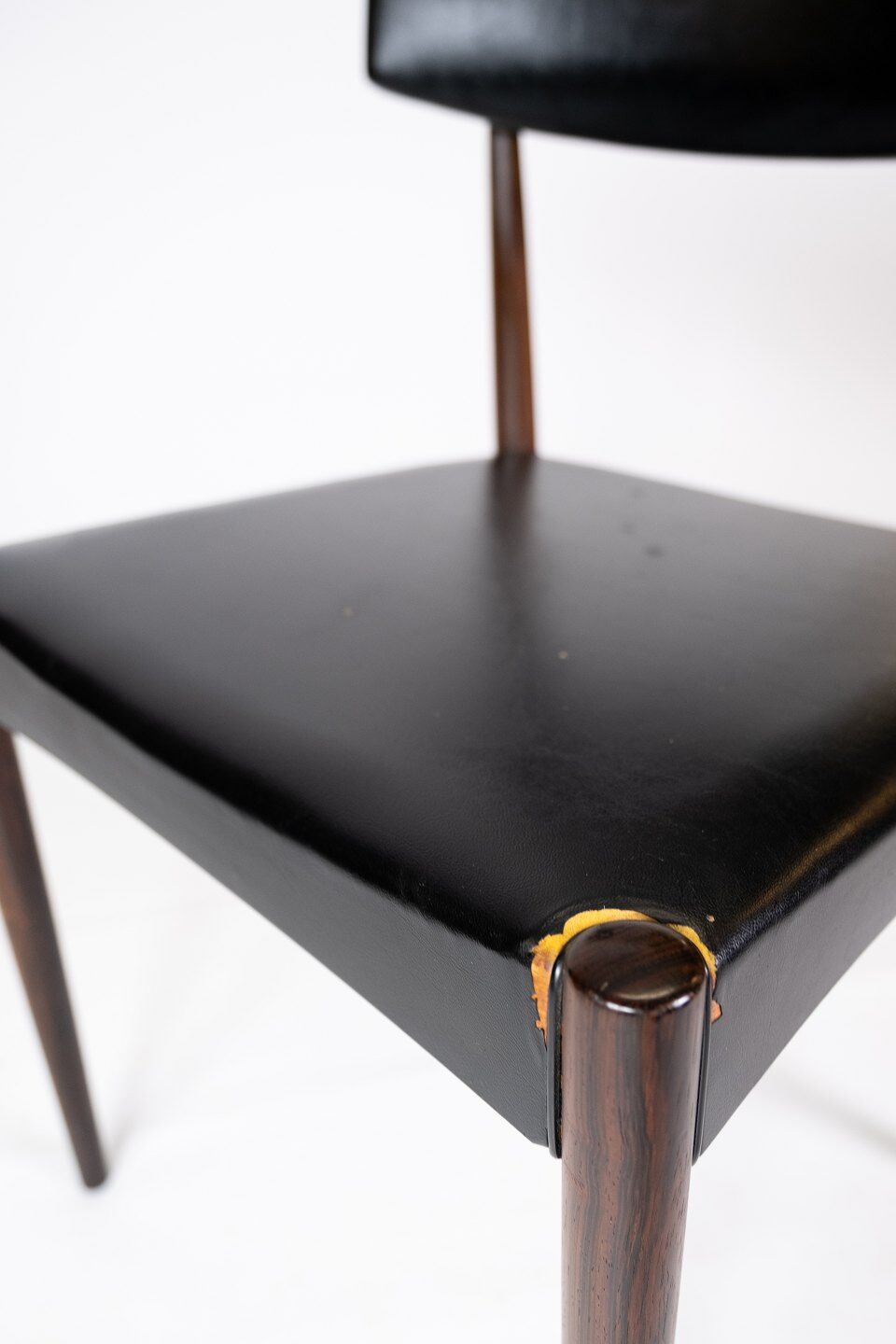 Set of four dining room chairs in rosewood and black leather of danish design from the 1960s.