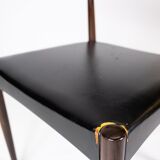 Set of four dining room chairs in rosewood and black leather of danish design from the 1960s.