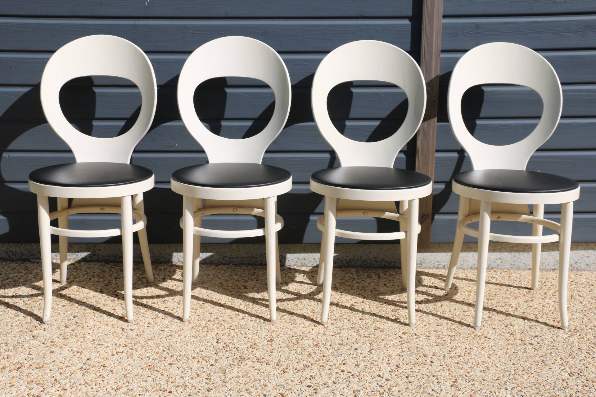 6 baumann chairs, white gull with black faux leather.