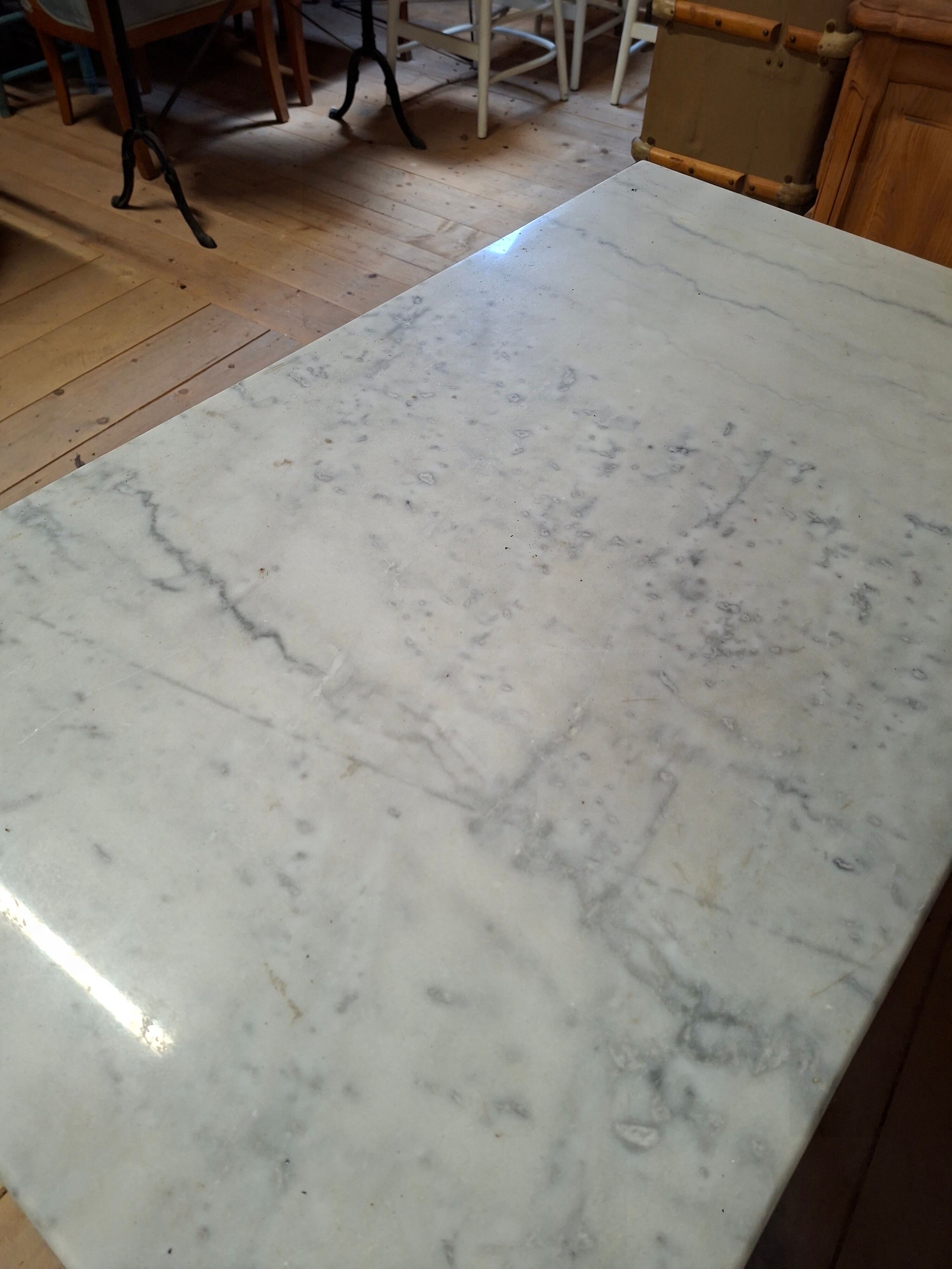 Pair of bistro tables in marble and cast iron.