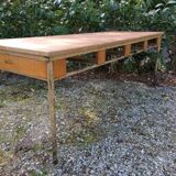 Vintage modernist table with metal tubular base and top covered with oilcloth.