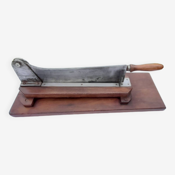 Old bread cutter on wooden base L 60 cm