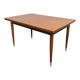 Vintage extendable dining table with tapered legs.