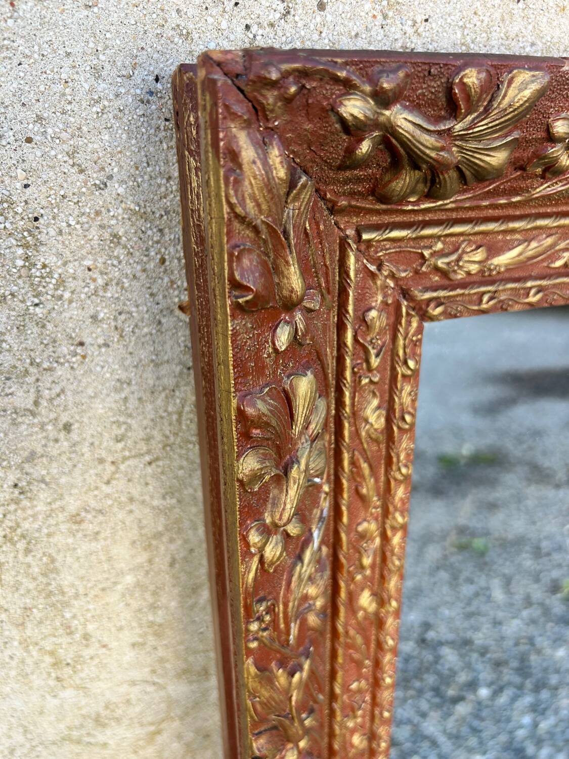 Antique mirror in patinated gilt wood