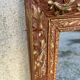 Antique mirror in patinated gilt wood