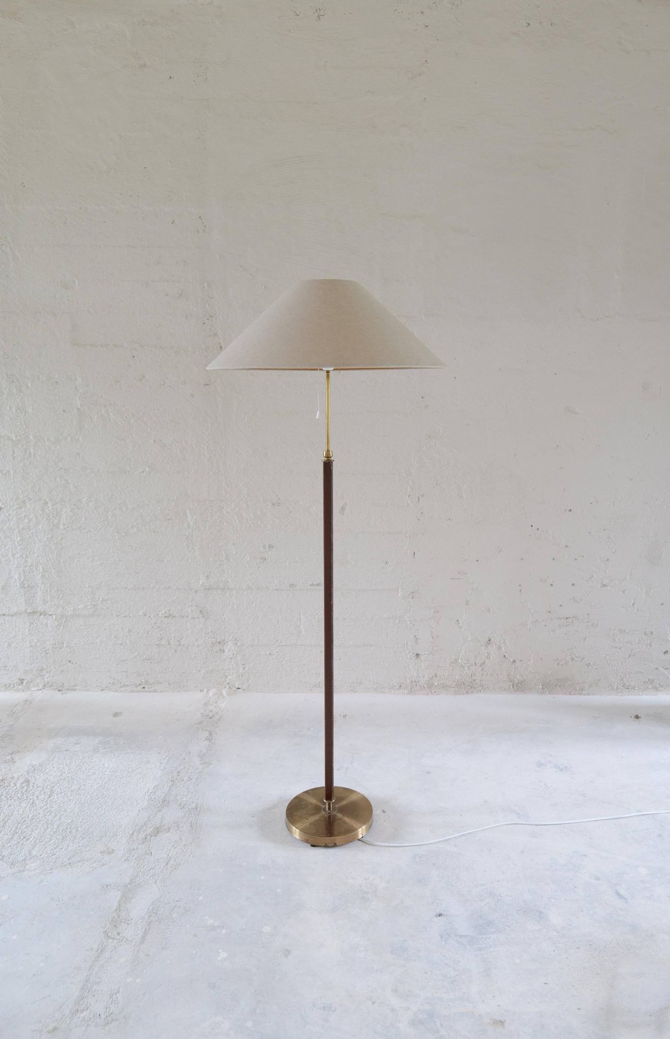 Mid-century brown leather and patinated brass floor lamp by Falkenbergs Belysning, Sweden, 1960s.