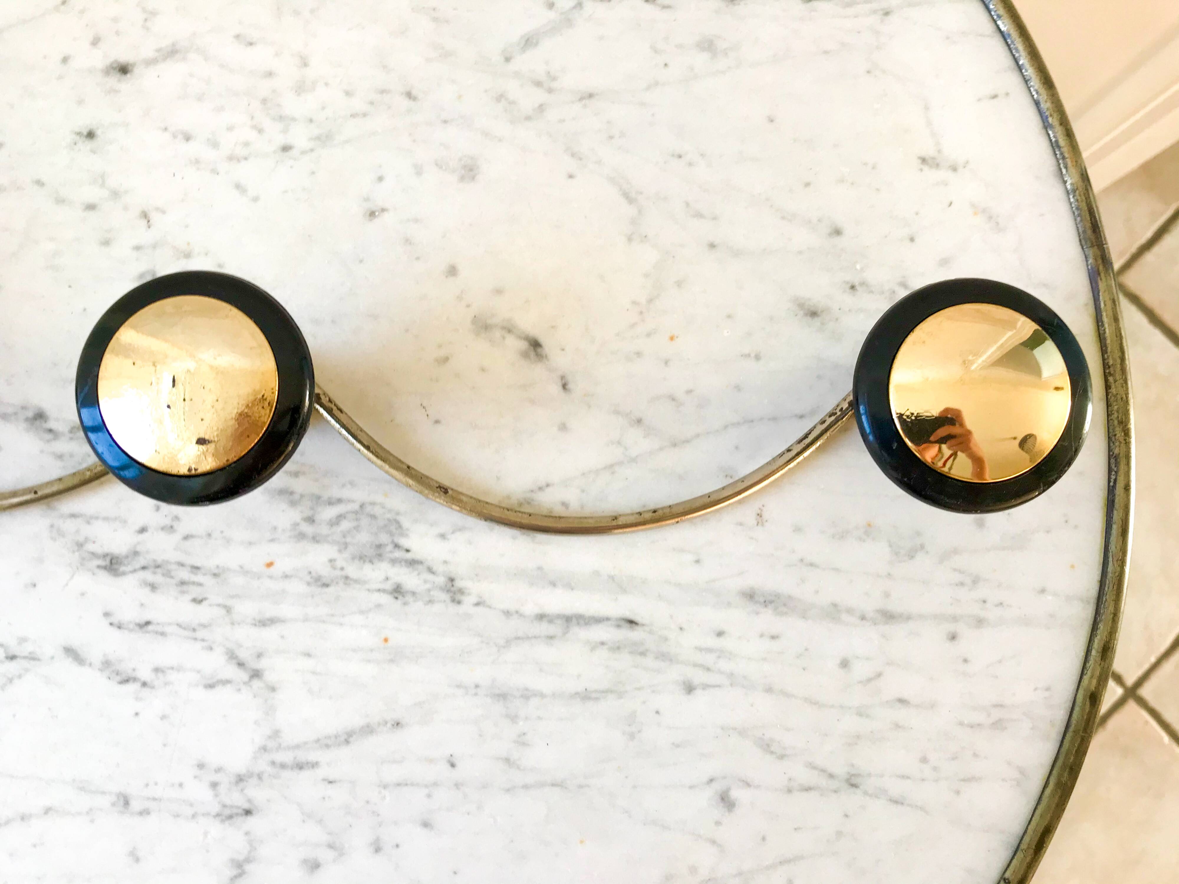 silver and black metal coat hook from the 70s