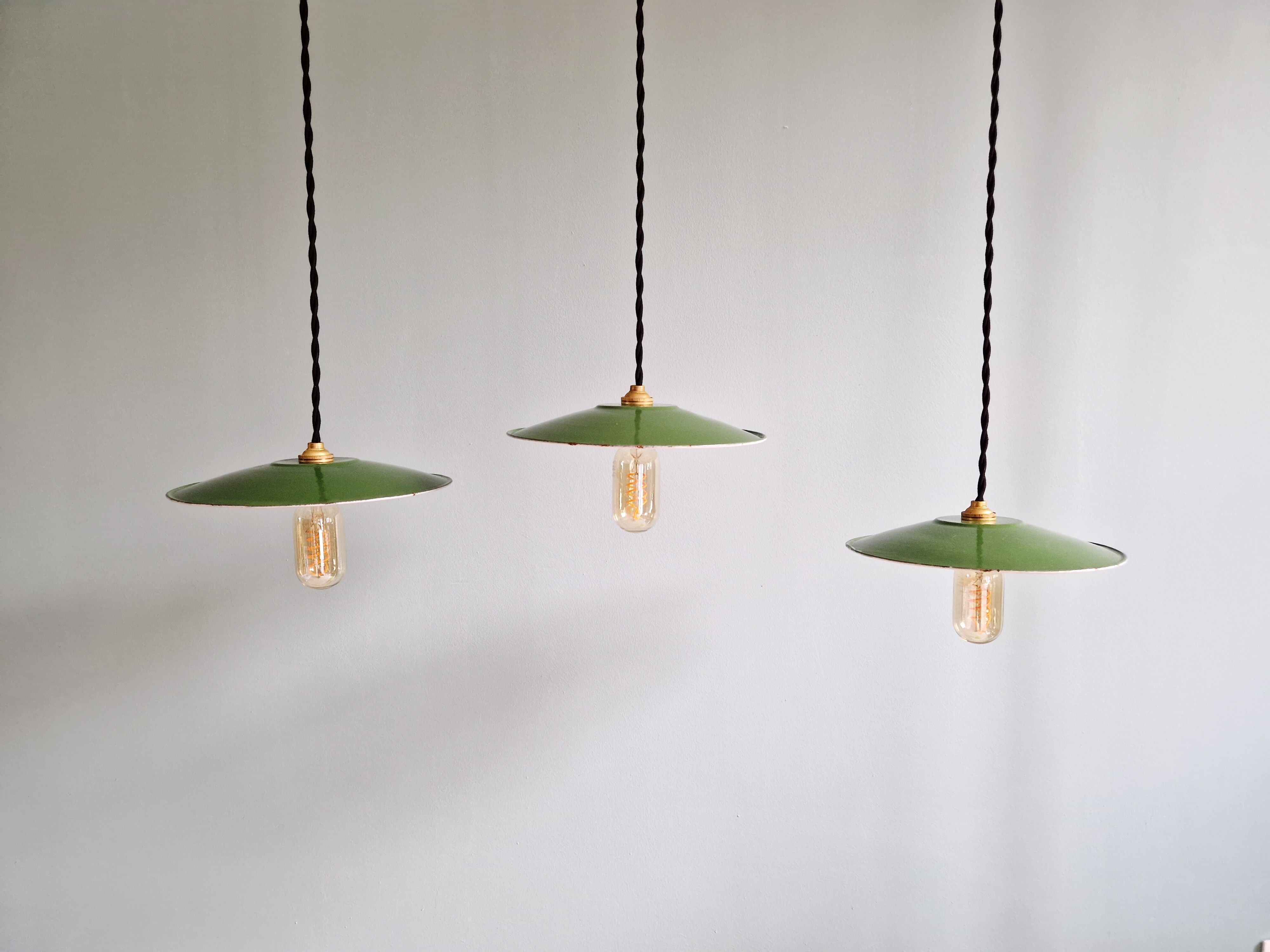 Trio of large industrial suspensions in green enamelled sheet metal.