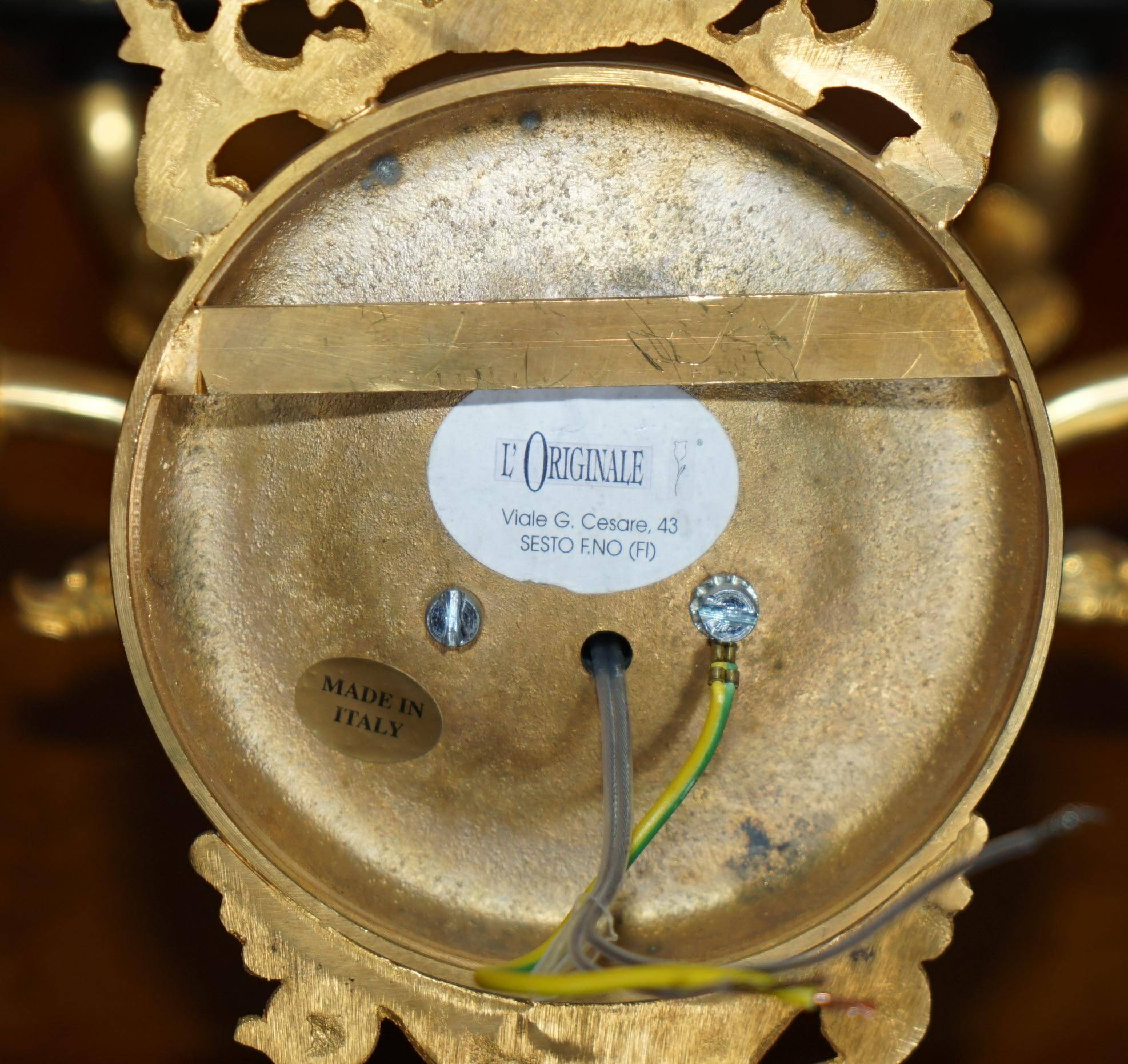Pair of L'Originale wall sconces plated with 24-carat gold featuring four bronze candles.