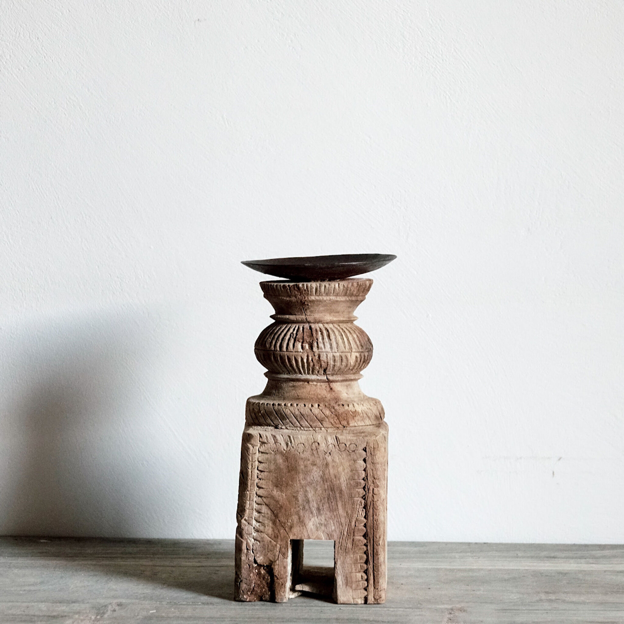 Candle holder in light carved wood