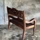 Small antique Indonesian bench in carved teak with plant and floral motifs.