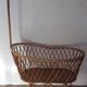 Vintage rattan cradle with its spire
