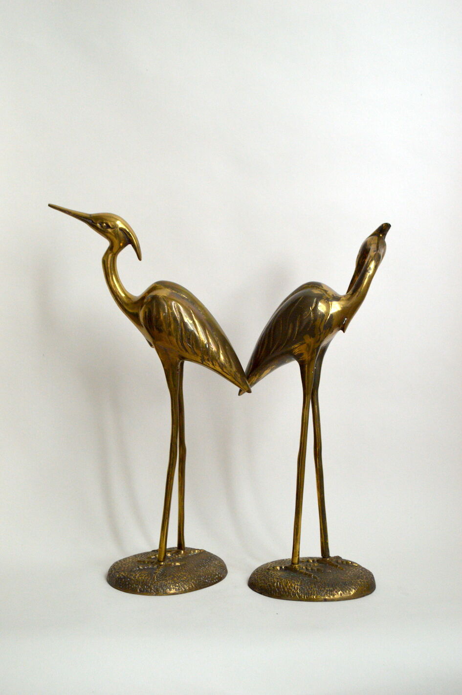 Brass herons couple