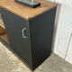 Small vintage black buffet with sliding doors.