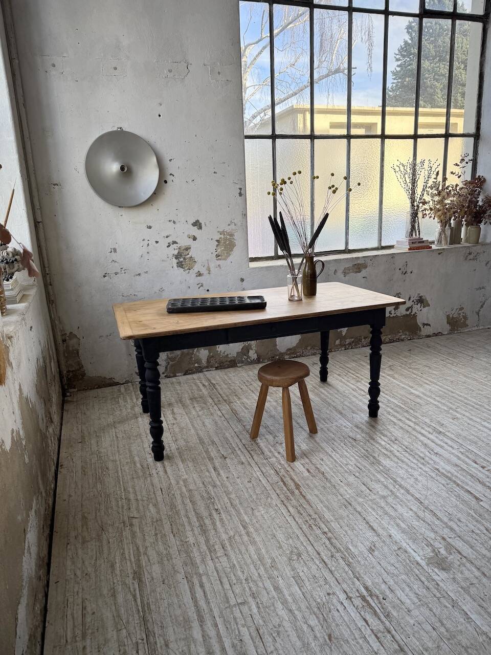 Oak farmhouse table with turned black legs.