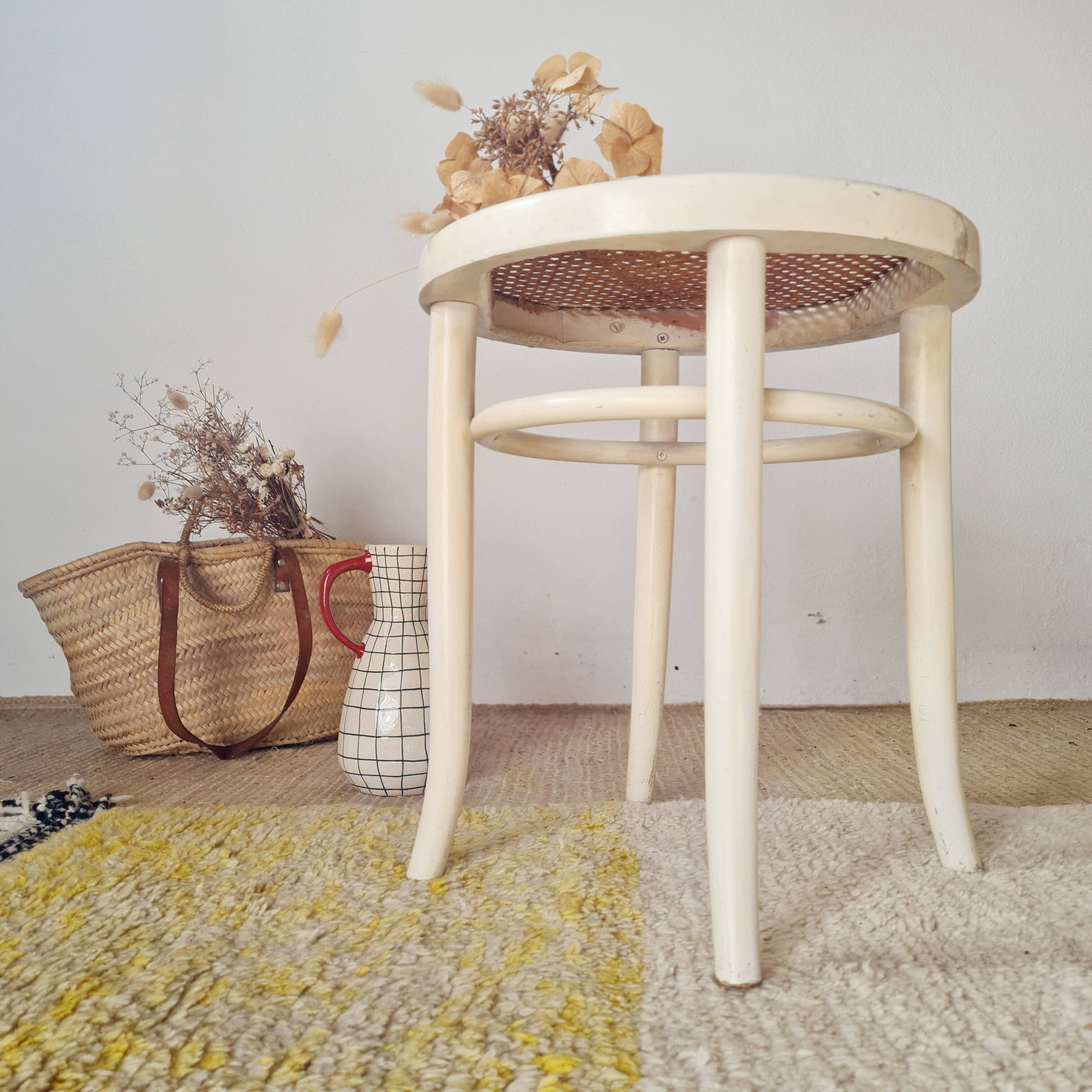 Antique stool with wood and cream caning.