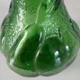 Green glass vase decorated with bunch of grapes and fruits