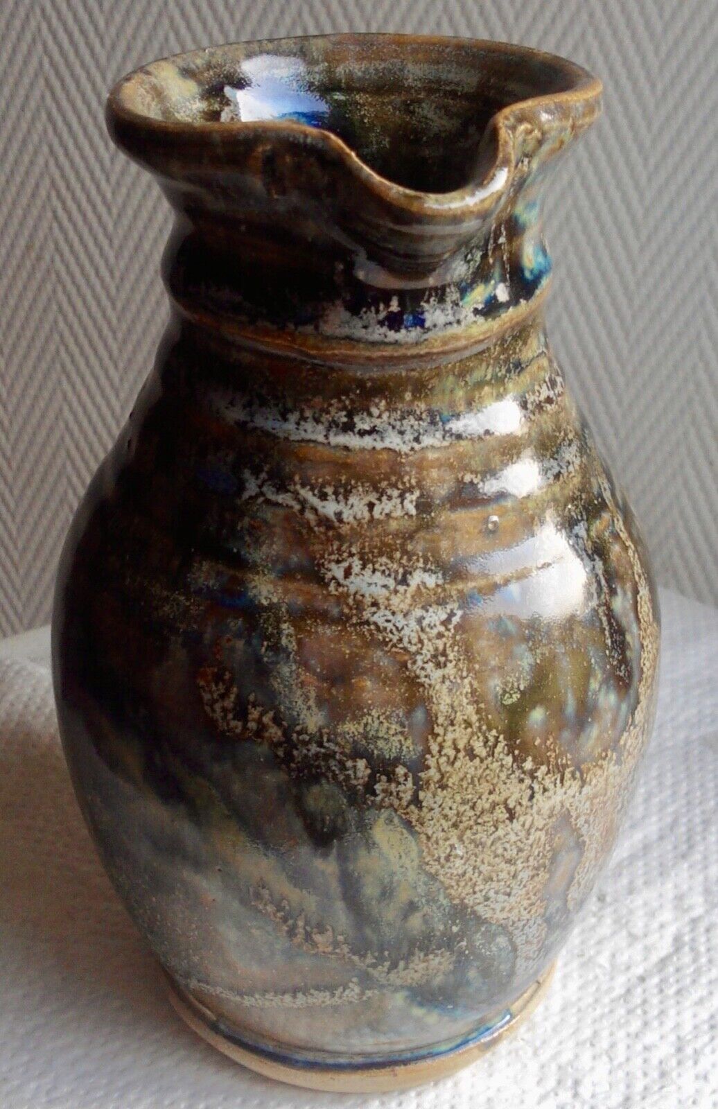 Enamelled ceramic pitcher, signature mb the terminal