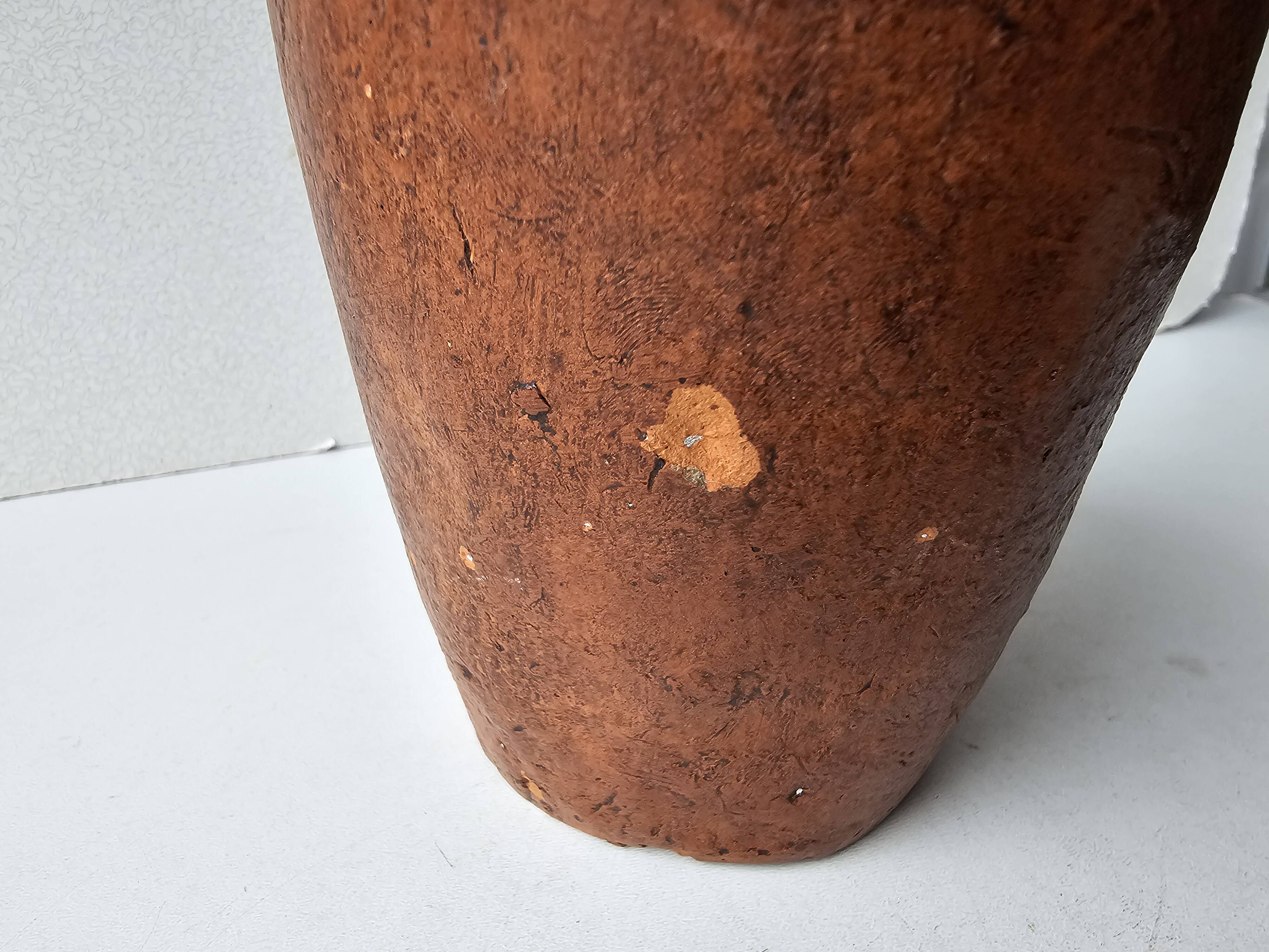 Terracotta face sculpture in African art style