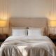 Pair of large brushed metal lamps with cream shades.