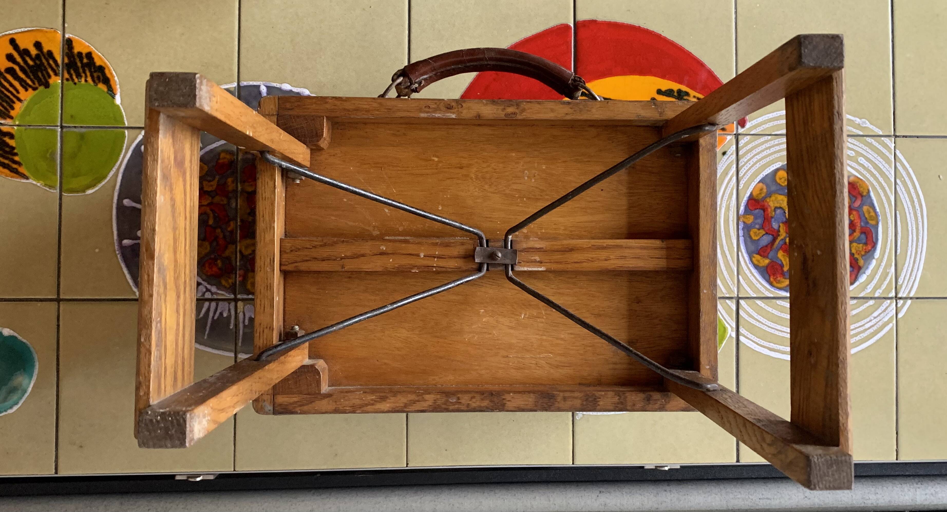 Old foldable fisherman's stool in wood and leather
