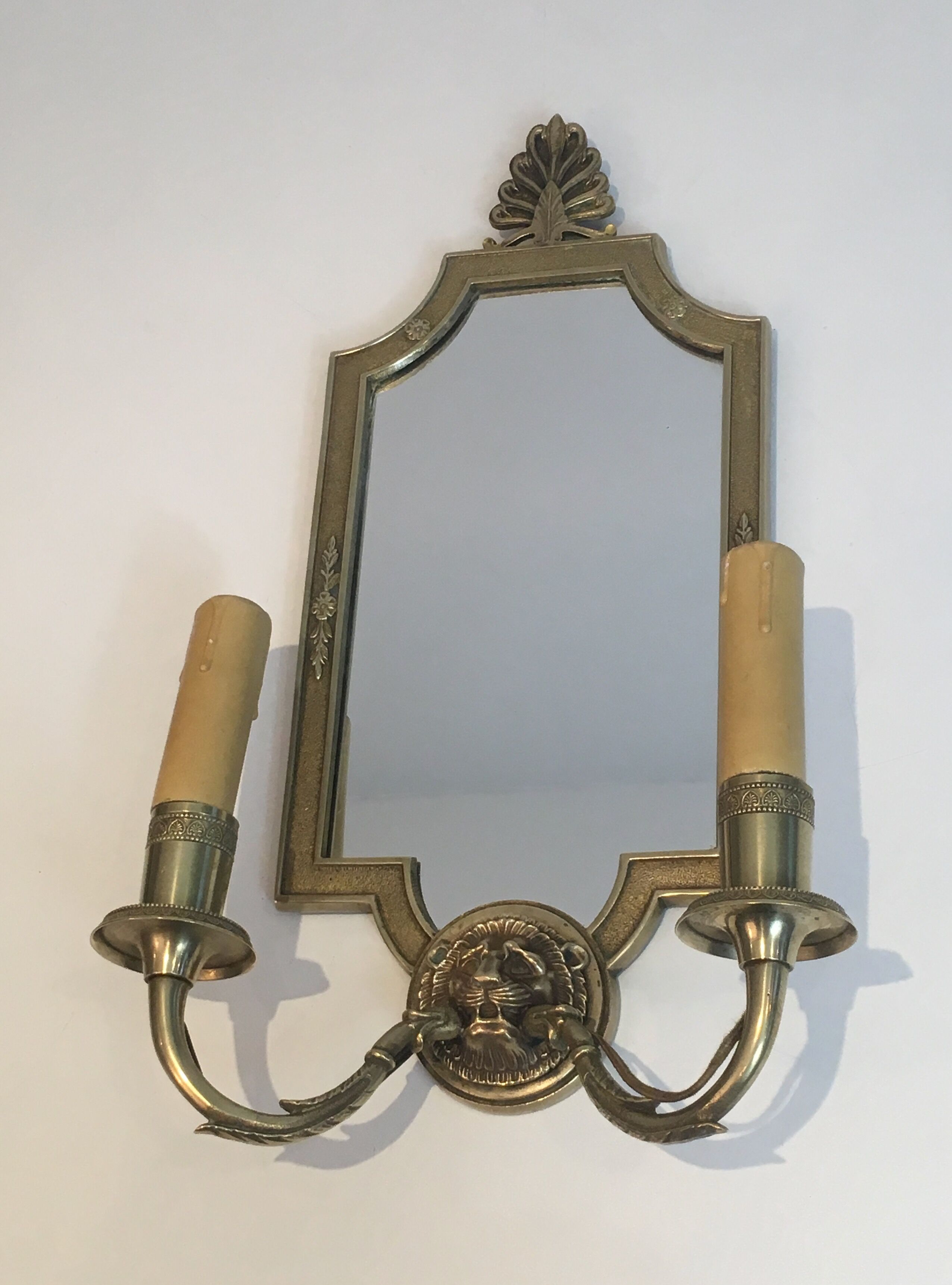 Pair of mirror and bronze wall lamps with lions' heads, french work. around 1940
