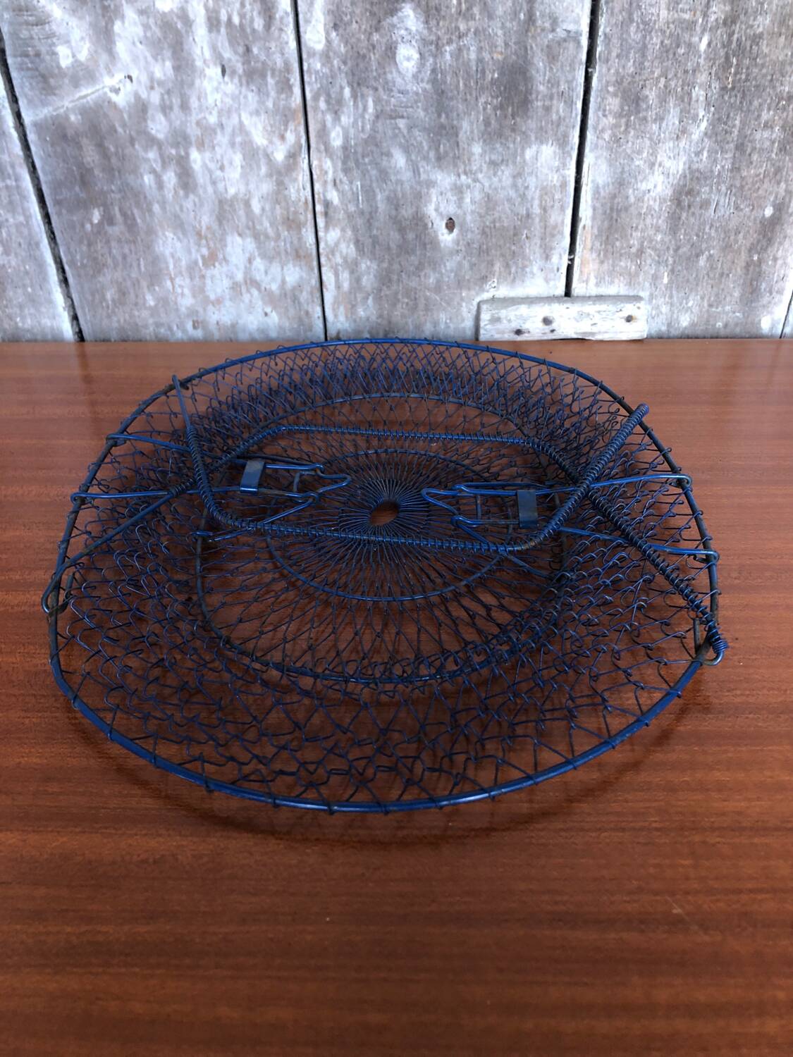 Old foldable blue metal basket, vintage handles