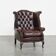 Fauteuil à oreilles Chesterfield en cuir de vache marron