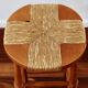 Antique wooden bar stool with a straw seat