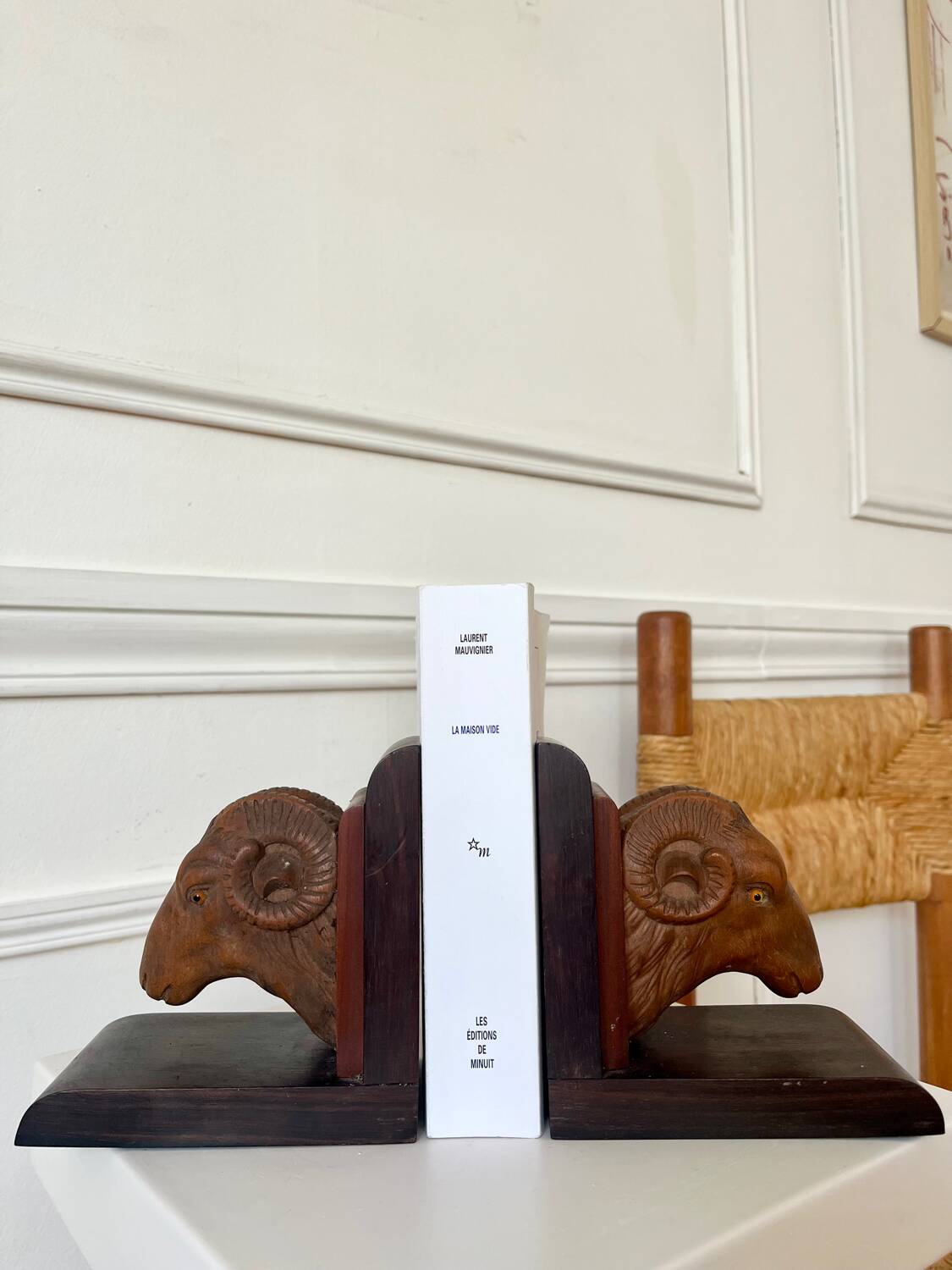 Pair of carved wooden bookends in the shape of ram's heads.